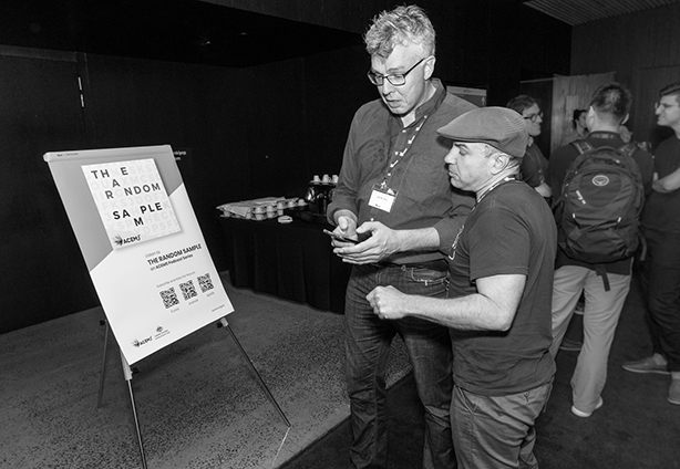 Aaron from Podcast services Australia assisting ACEMS CI Jan de Gier to download the podcast at The Random Sample launch party